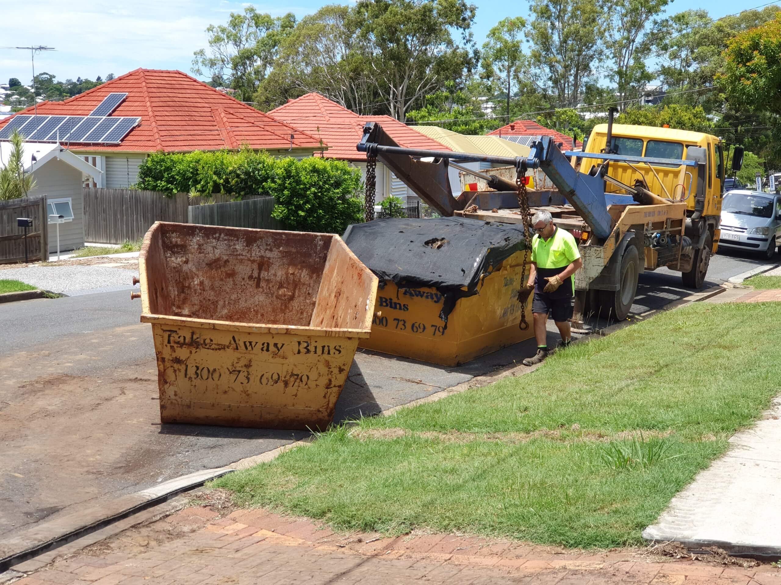fetching skip bin with garden waste in Colmslie